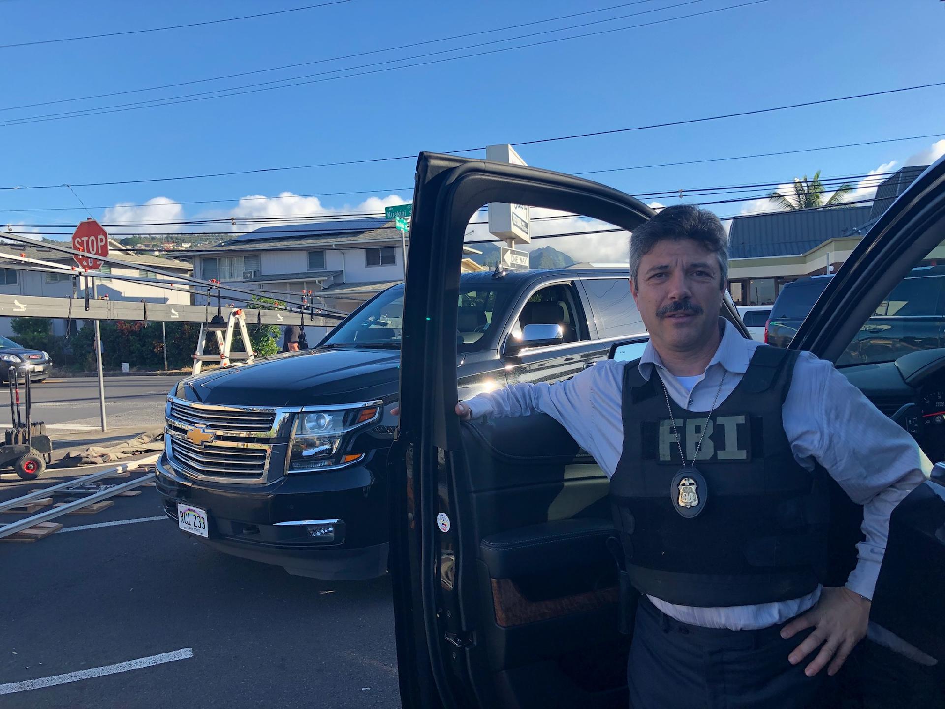 Elliott takes direction on set prior to FBI chase scene